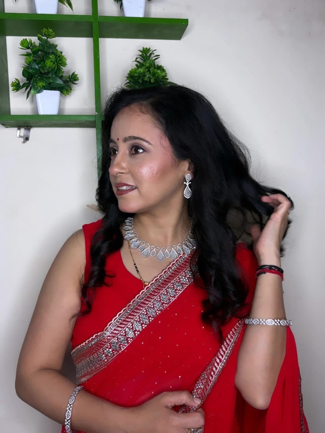 Glowing party makeup look in a red saree by Priya Maleri, Tricity